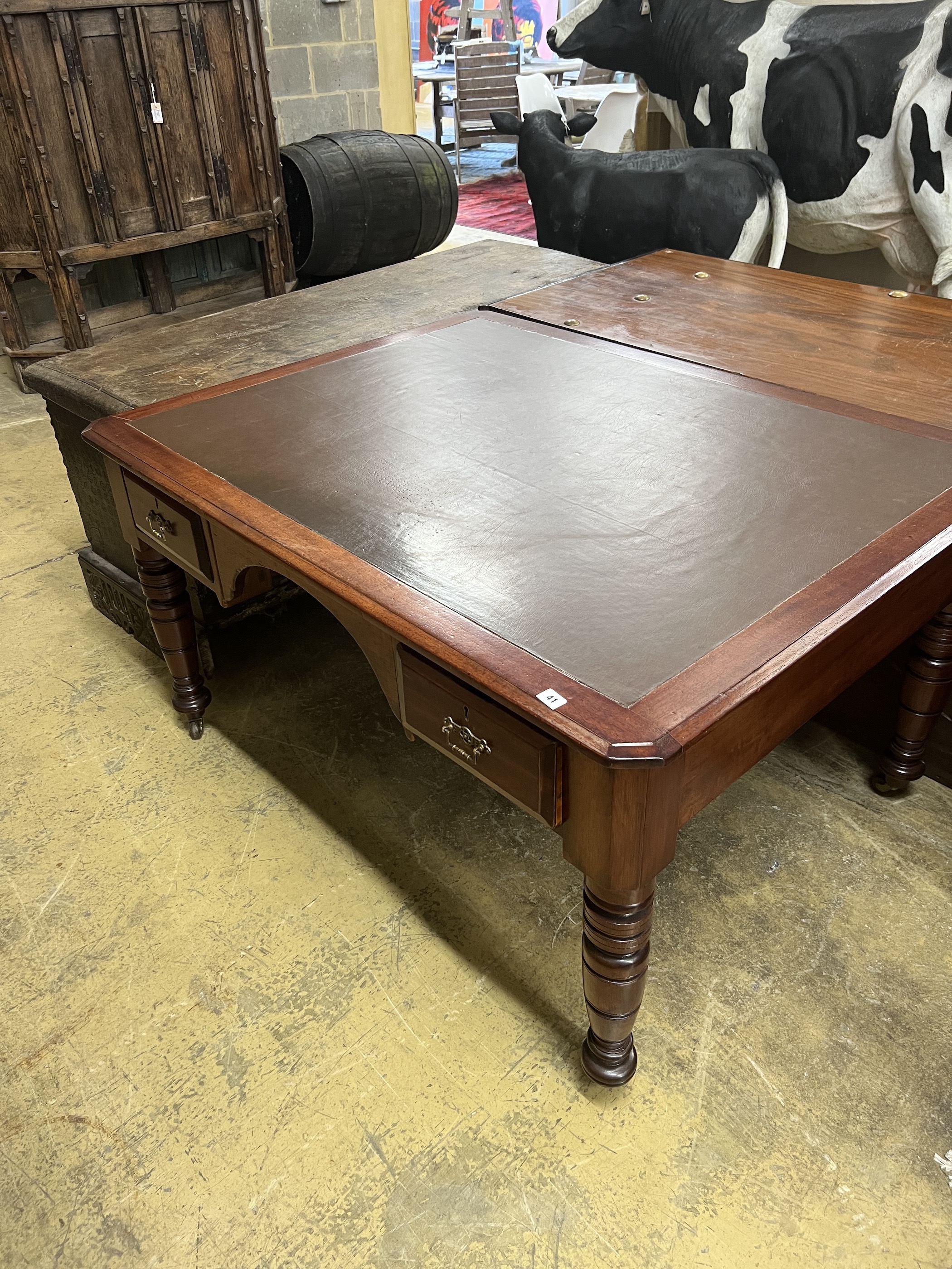 A late Victorian mahogany and cedar kneehole writing table, width 137cm, depth 107cm, height 75cm